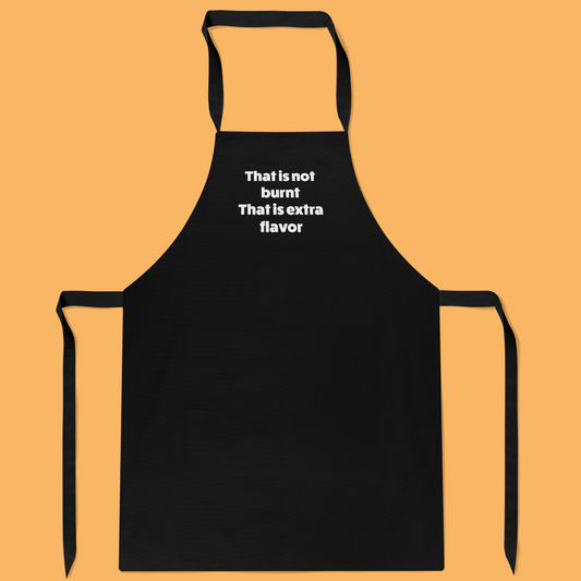 Keukenschort zwart met grappige tekst - It’s not burnt. It’s extra flavour