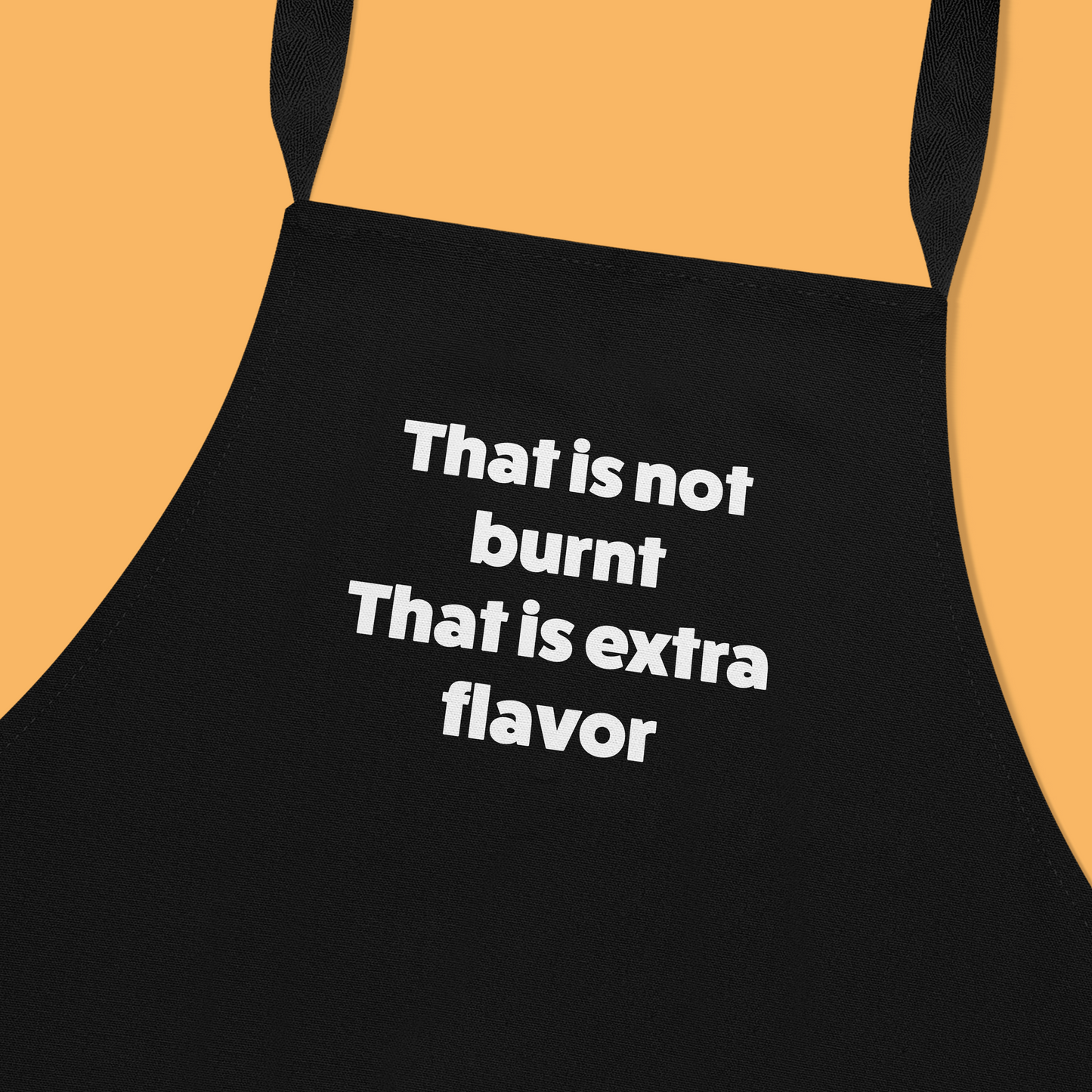 Keukenschort zwart met grappige tekst - It’s not burnt. It’s extra flavour