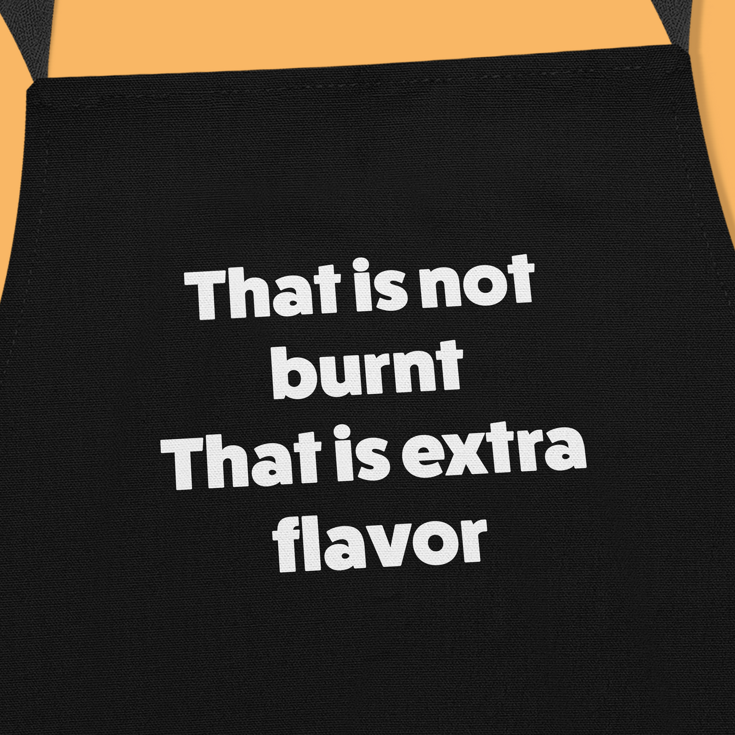 Keukenschort zwart met grappige tekst - It’s not burnt. It’s extra flavour